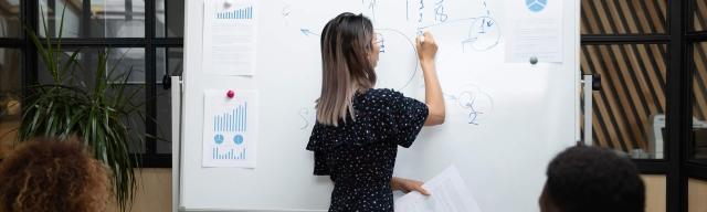 woman-writing-on-whiteboard