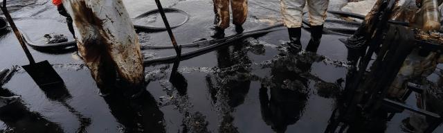 Emergency response team in PPE standing in sludge