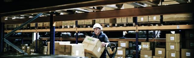 Person moving boxes in Warehouse 