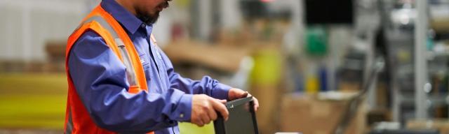 man inspecting refurbished monitor 