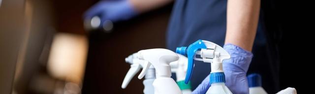 housekeeper with cleaning supplies