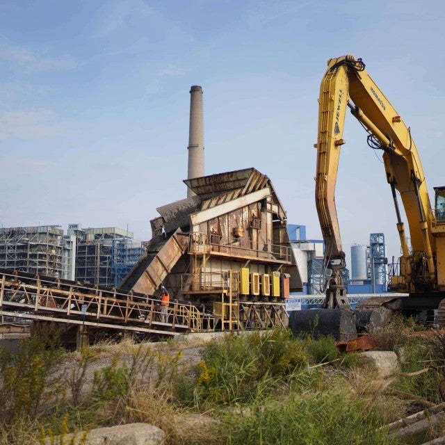 dredge work site with city in the distance