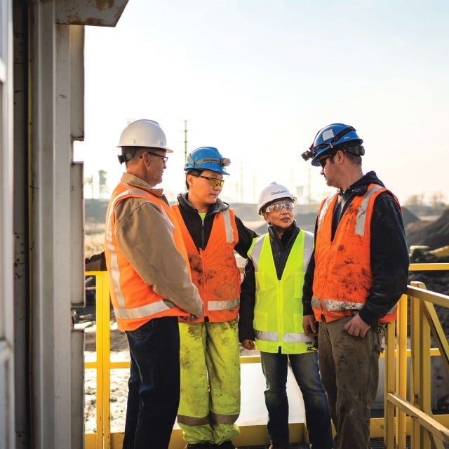 team members meeting on balcony at dredge site 