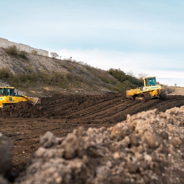 bulldozers moving dirt at work site