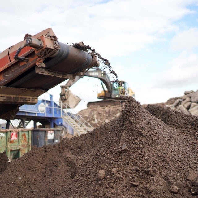 soil on a conveyor belt at worksite 