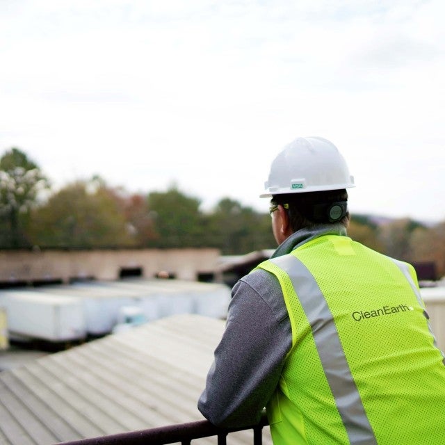 Back of person overlooking truck loading area at facility 