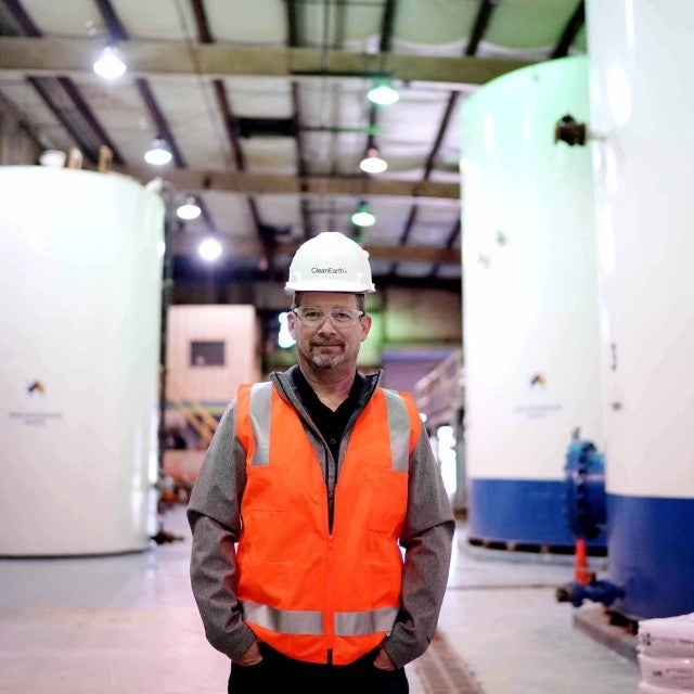 Person standing in warehouse of wastewater tanks 