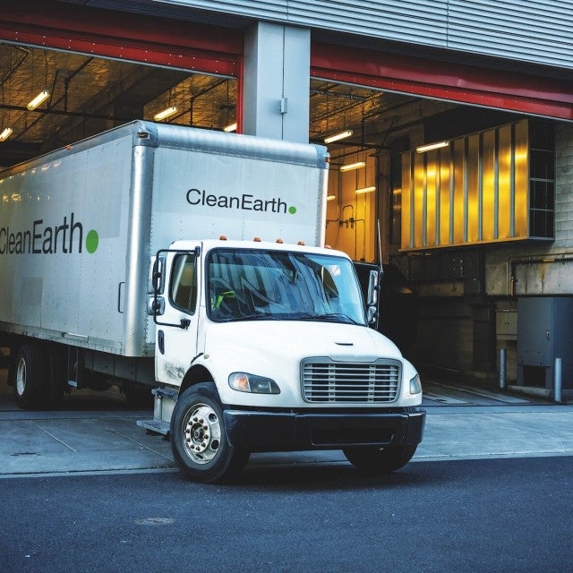 clean earth truck pulling out of garage