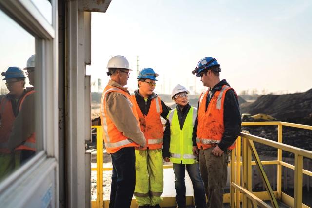 team members meeting on balcony at dredge site 