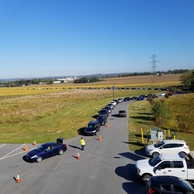 Line of cars waiting at collection event
