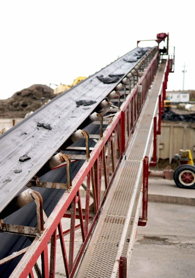 dredged material on conveyor belt at worksite