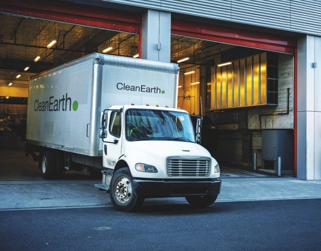 clean earth truck pulling out of garage
